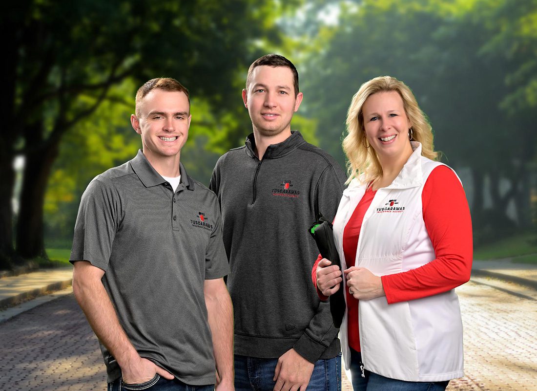 Farm Insurance -Agency Agriculture Insurance Agent Team Members Standing on a Cobblestone Street With Green Trees in the Background